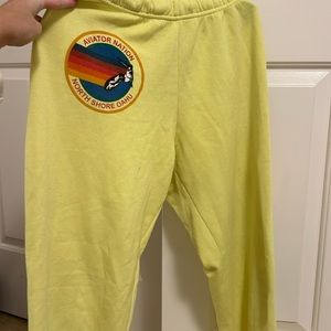 Aviator Nation Neon Yellow Sweatpants with logo and written down the leg